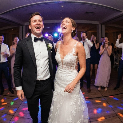 Happy wedding couple dancing on a dance floor with dynamic lighting