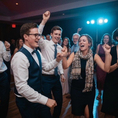 Wedding guests happily dancing on a dance floor with ambient lighting